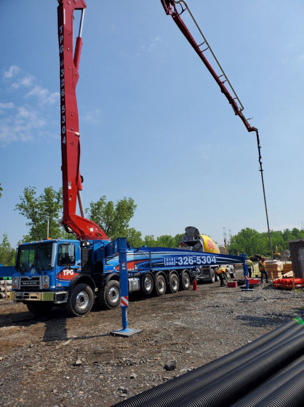 Concrete pumping on jobsite and placing booms nearby | TPG Concrete Pumping